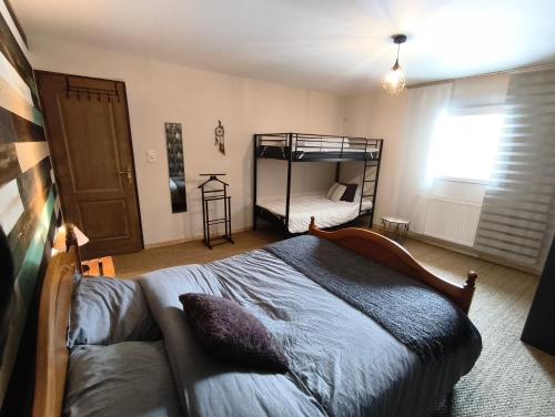 a bedroom with a bed and a couch in it at Gîte des trois petits oiseaux in Picarreau