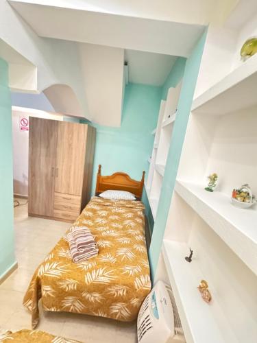 a bedroom with a bed in a room with shelves at ADA & Gran Alacant & Vacation in Gran Alacant