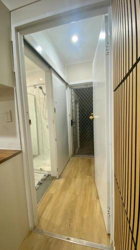 an empty hallway with a door to a room at Modern Studio Room Retreat in Harristown