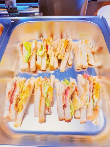 a group of sandwiches on a plate on a tray at Amanda Hotel堆谷里酒店 in Phnom Penh