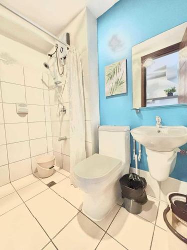 a bathroom with a toilet and a sink at Luxurious condo with City View in Horizons 101 in Cebu City