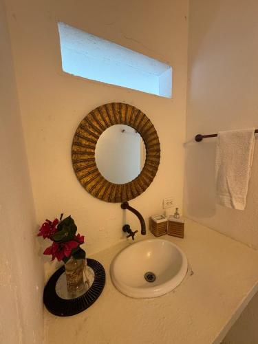 a bathroom with a sink and a mirror on a counter at Casa Rosario in Isla Grande