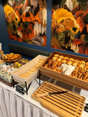 a buffet with bread and pastries on a table at Hotel Terminus Lyon in Paris