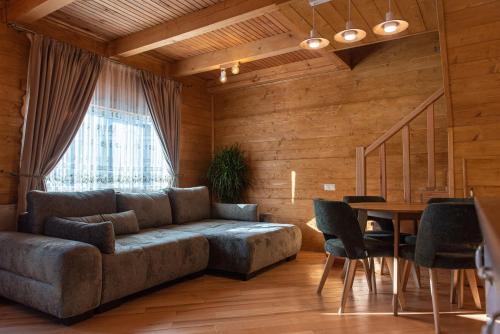 a living room with a couch and a table at Zolota Forel Hotel in Korostov