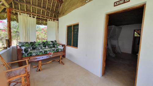 a living room with a couch and a window at Kirepwe Ecco Camp Watamu in Watamu