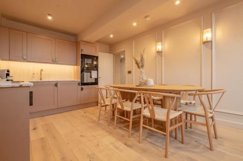 a kitchen with a wooden table and chairs at Luxury Quayside Loft Sleeps 6 in Newcastle upon Tyne
