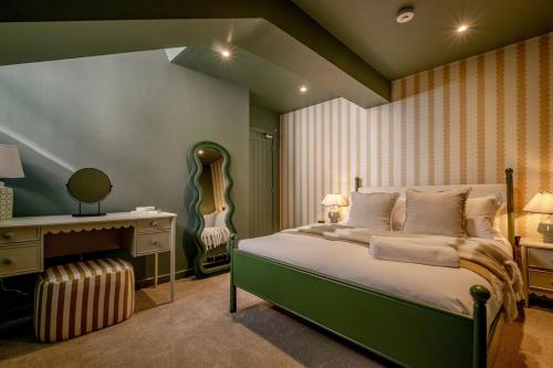 a bedroom with a bed and a desk and a guitar at Luxury Quayside Loft Sleeps 6 in Newcastle upon Tyne