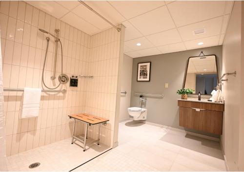 a bathroom with a shower and a toilet and a sink at Spring Mill Inn in Mitchell
