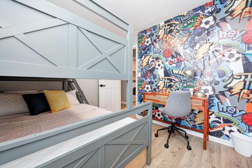 a bedroom with a bunk bed and a wall covered in graffiti at 5 min to Grand Park, 1Level, Stocked Kitchen, King Bed, GameRm, Firepit, BBQ, Pet Friendly in Westfield