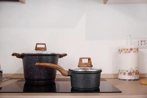 two pots sitting on top of a stove at Casa Andrea e Linda in Germignaga