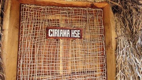 a sign on the side of a building with a rattan wall at Kirepwe Ecco Camp Watamu in Watamu