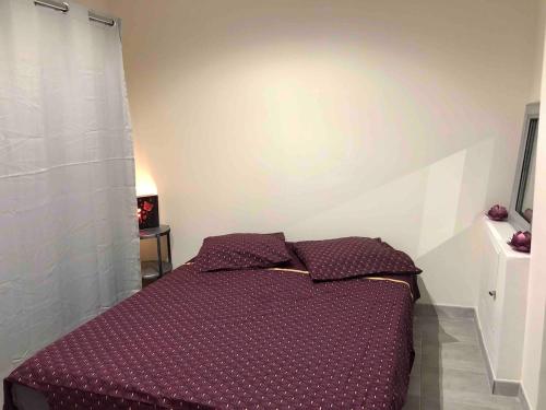 - une chambre avec un lit doté de draps et d'oreillers violets dans l'établissement Villa La Mer new apartment 75 m2 very quiet, à Cagnes-sur-Mer