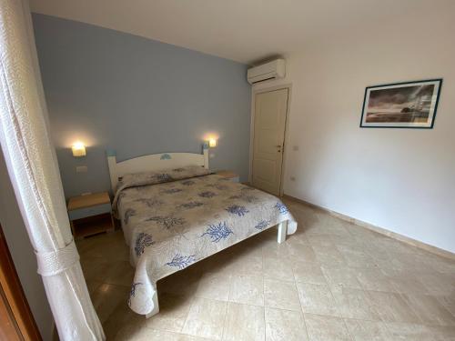 a small bedroom with a bed in a room at Seaview Apartment (N°23) in Porto Pozzo