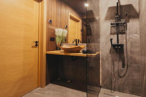 a bathroom with a sink and a shower at Sunset Retreat in Ainaži