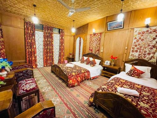 a bedroom with two beds in a room with curtains at HB Freedom group of Houseboats in Srinagar