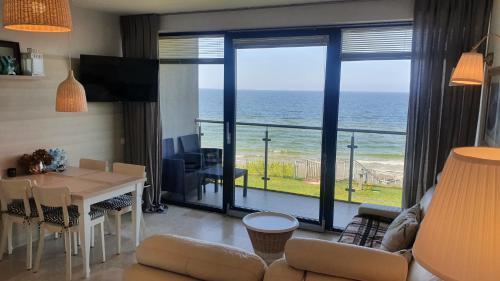 a living room with a view of the ocean at Apartament Marzanna w Willi na Klifie in Rewal