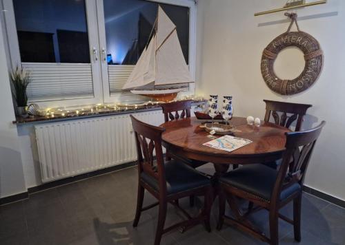 a dining room with a wooden table with a boat on the wall at Bremen City in Bremen