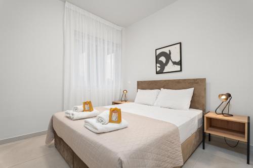 a bedroom with two beds with towels on them at Anchora in Paralimni