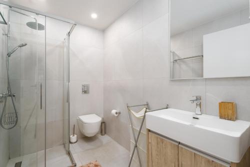 a bathroom with a toilet and a sink and a shower at Anchora in Paralimni