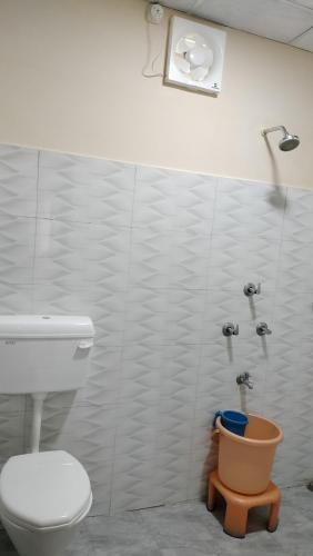 a bathroom with a toilet and a shower at Bononi in Jorhāt