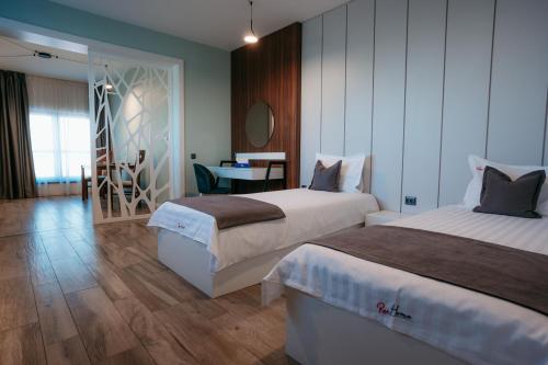 a hotel room with two beds and a table at ResHome Apartments&Rooms in Focşani