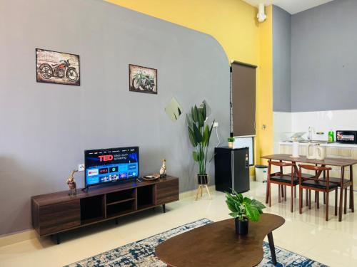 a living room with a tv and a table at Core Soho Suites Kota Warisan Sepang KLIA Airport Free Wifi by BKA LEGACY in Sepang