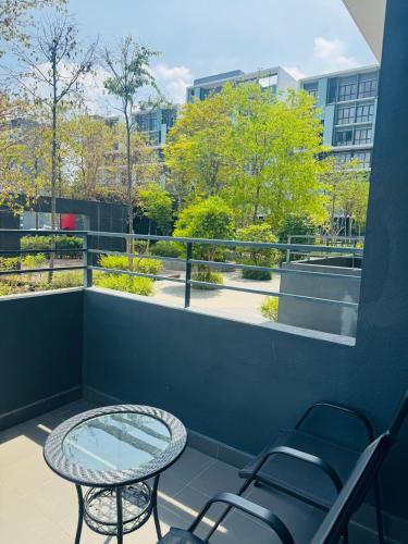 a balcony with a table and chairs and a window at Core Soho Suites Kota Warisan Sepang KLIA Airport Free Wifi by BKA LEGACY in Sepang