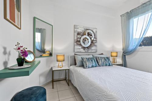 a bedroom with a bed and a mirror at Iris Bloom Holiday Apartment in Paphos City