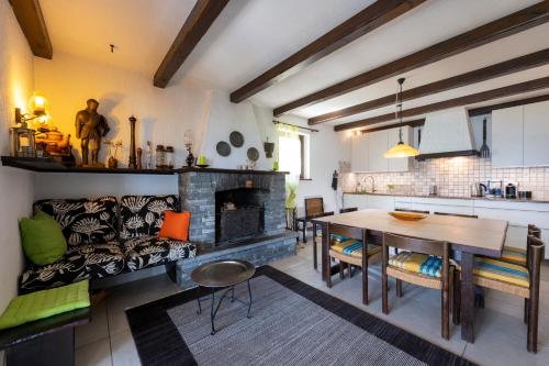 a living room with a table and a fireplace at casa-castagna pianterreno in Contra