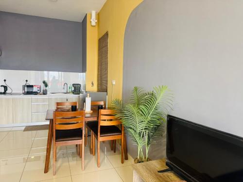 a kitchen and dining room with a table and a tv at Core Soho Suites Kota Warisan Sepang KLIA Airport Free Wifi by BKA LEGACY in Sepang