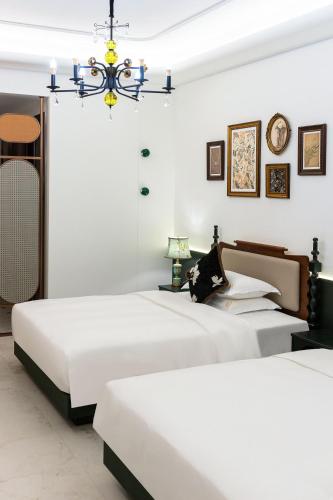 Postel nebo postele na pokoji v ubytování Vishan Garden Boutique Hotel 厦门维尚花园潮宿 中山路步行街店