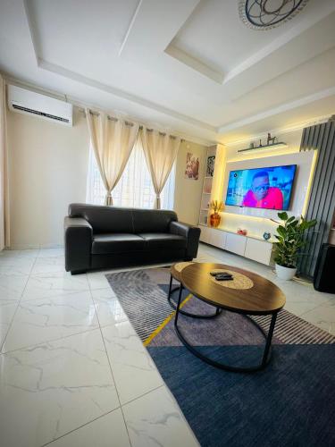 a living room with a couch and a coffee table at Nouvelle BNB in Gaborone
