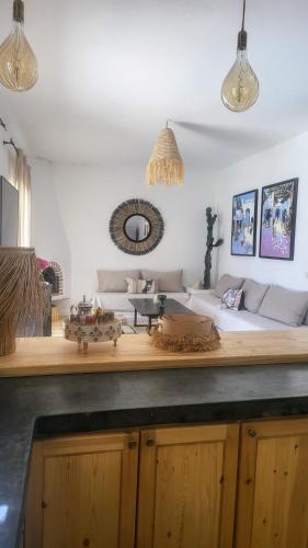 a living room with a couch and a table at Villa Dar Mira - Ghazoua Essaouira in Ghazoua