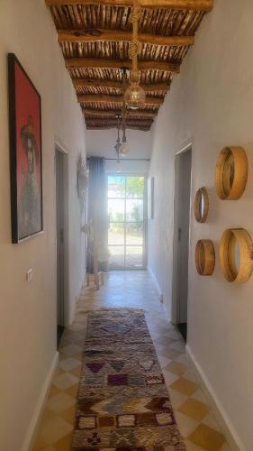 a hallway with a room with a rug on the floor at Villa Dar Mira - Ghazoua Essaouira in Ghazoua