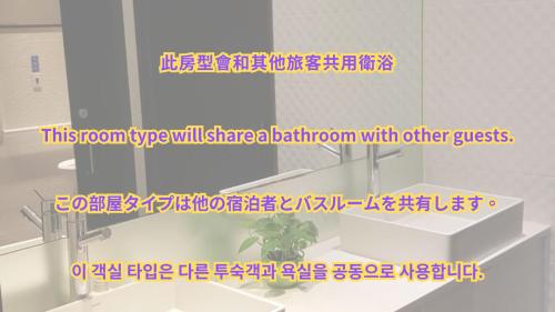 a mirror in a bathroom with a sink at Queens Hotel II in Taipei