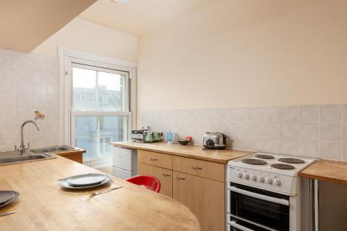 a kitchen with a stove and a counter top at Abbey Terrace - Free Parking in Whitby