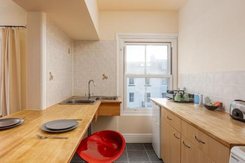 a kitchen with a counter and a sink and a window at Abbey Terrace - Free Parking in Whitby