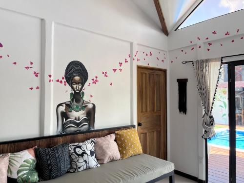 a room with a statue on the wall with a couch at Mecca in Puerto Viejo