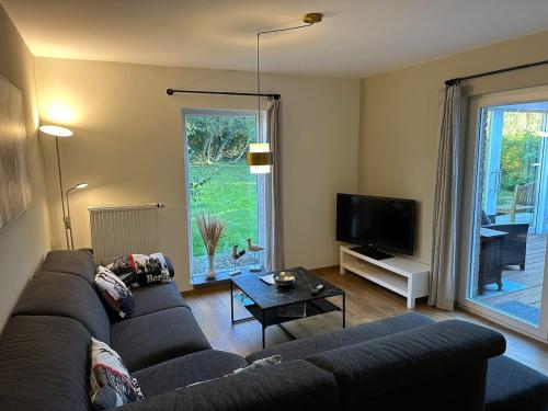 a living room with a couch and a tv at Raelax in Raeren