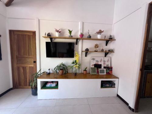 a living room with a table and a tv at Mecca in Puerto Viejo