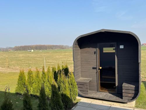 a small shed with a door in a field at Romantik-Wohnung - Auszeit-Momente mit Sauna in Syke