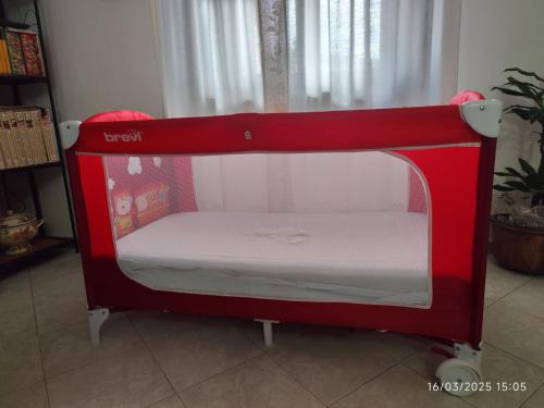 a red pretend bed in a room at Enchanting Flat with Patio in Abbadia a Isola in Monteriggioni