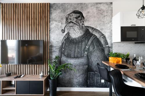 a wall mural of a man with a pipe at FLATMORE Apartament Matejki 21A m20 in Zielona Góra