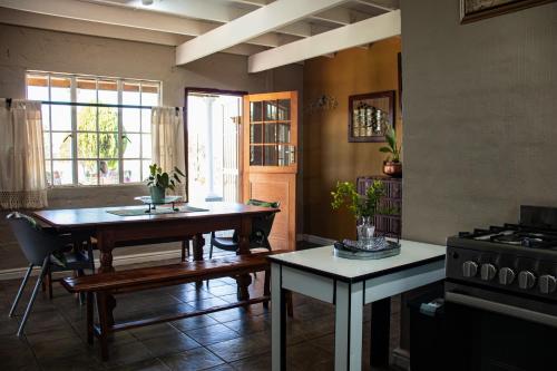 a living room with a table and a stove at Tranquility Farmstays in Winterton