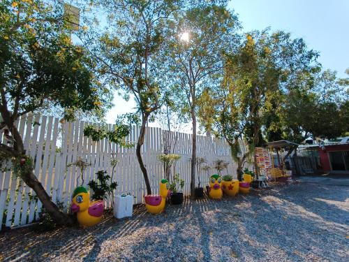 a fence with a row of inflatable rubber ducks at Saan Rak Resort in Prachuap Khiri Khan