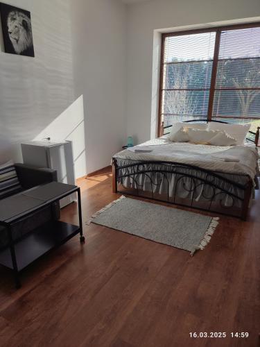 a bedroom with a bed and a large window at Villa Homestay Nad Helmrovkou in Prague