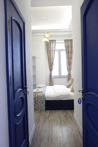 a bedroom with a bed and a window at Ithaca in Yerevan