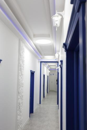 a hallway with blue and white walls and ceilings at Ithaca in Yerevan