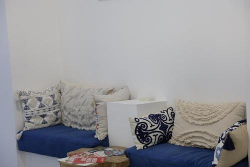 a living room with two blue couches and pillows at Ithaca in Yerevan