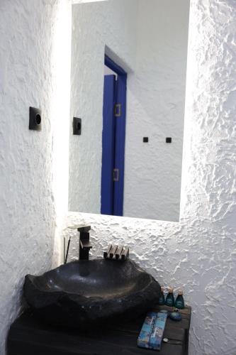 a bathroom with a black tub in front of a mirror at Ithaca in Yerevan